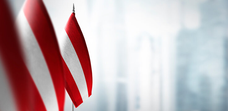 Small flags of Austria on the background of a blurred background