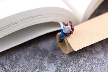 Miniature creative books and diplomas and people who read