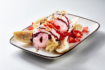 Gourmet banana split sundae with strawberries and cream