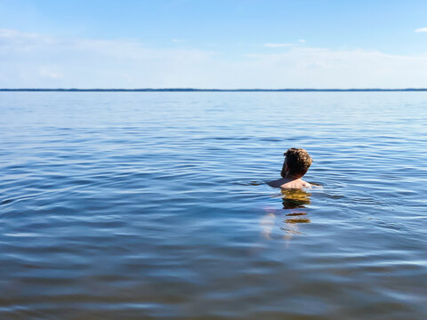 Man swimming in lake in sweden
