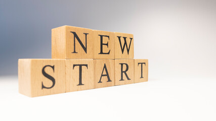 The word new start was created from wooden cubes. life and psychology.