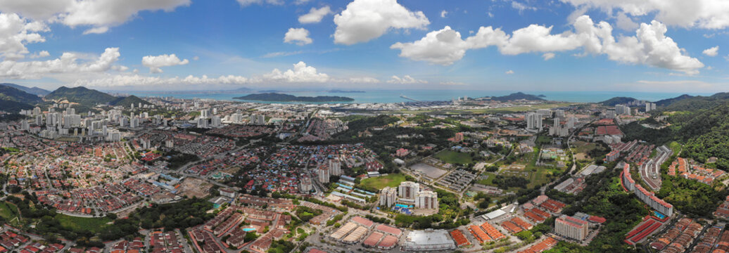 Aerial view of Bayan Lepas Industrial park, residential houses and commercial shop building on a sunny day in Penang, Malaysia.