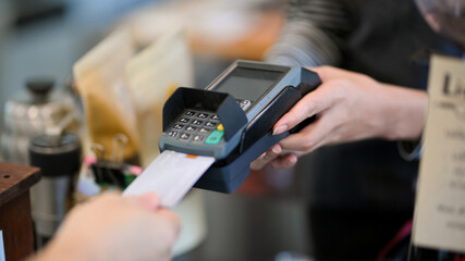 Closeup image of customer insert credit card in payment machine