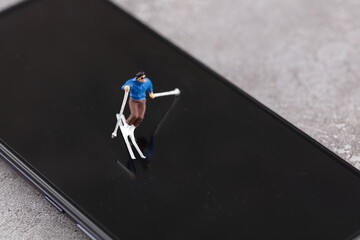 A skier swimming on a miniature creative mobile phone