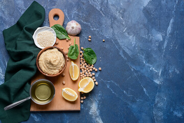 Composition with tasty hummus and ingredients on color background