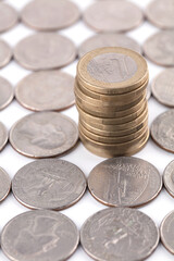 A stack of Euro coins in rolled out dollar coins
