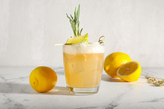 Glass Of Tasty Whiskey Sour Cocktail On White Background