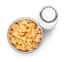 Bowl with tasty cornflakes and bottle of milk on white background