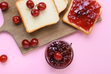 Sandwiches with tasty cherry jam on color background, closeup