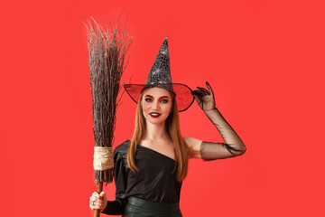 Beautiful woman dressed as witch for Halloween on color background
