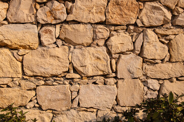 an artificial stone wall at sunny day for background