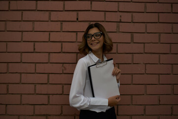 woman in white shirt documents work professional