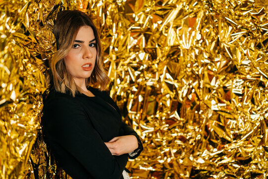 Sensual model in jacket against crumpled foil