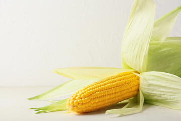 Fresh corn cob on light background