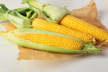 Fresh corn cobs on light background