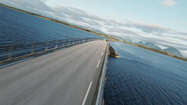 Winding Road Bridge Over Nordic Water In Fast Flying Over FPV Drone Shot