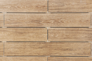 Facing the building with a ventilated facade. Wood texture, brown wood pattern. Close-up background.