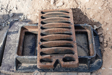 Storm sewer road hatch ready for installation. Close-up. Road works. Collection and disposal of...