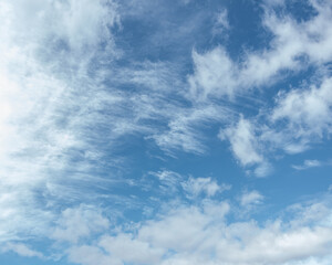 Cirrus clouds in the blue sky,beautiful Cirrus uncinus in the blue summer sky. Background of blue sky and white feathery clouds in summer.