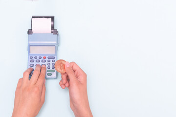 Payment for purchases with electronic money, bitcoin, e-commerce. Close-up of a hand holding a...