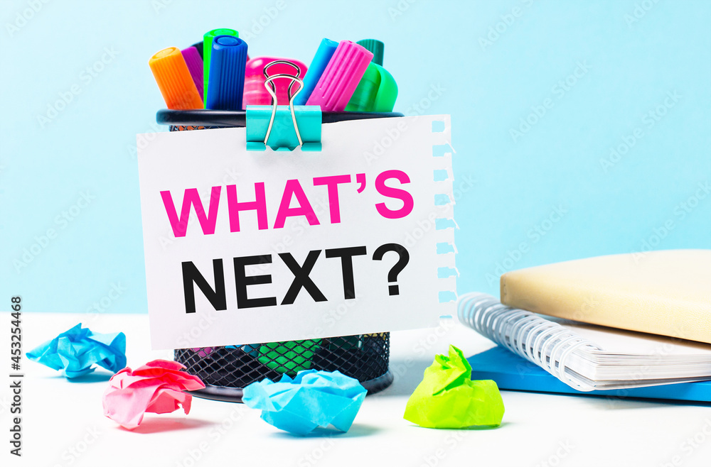 Poster on a blue background - a stand with bright markers, notepads and multi-colored crumpled pieces of pa