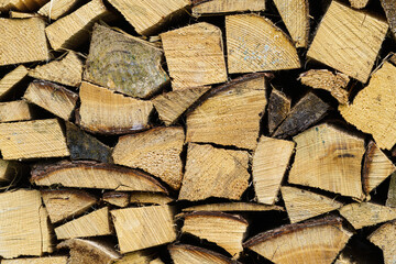 Stack of firewood prepared for winter. Spruce wood.