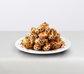 Babylon snail or sweet snail with chili salt. Isolated on white background. High quality image