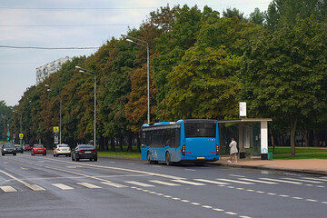 the bus at the bus stop on a morning in late summer