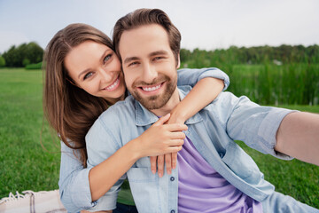 Photo of cheerful smiling good mood couple take selfie relaxing together outside outdoors wife cuddle husband love story