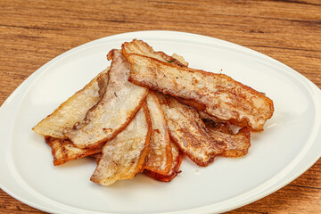 Roasted juicy bacon in the plate
