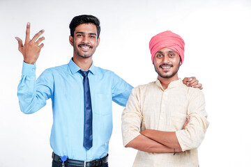 Naklejka premium Young indian officer with farmer on white background.