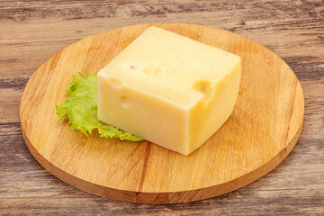 Emmental cheese over wooden board