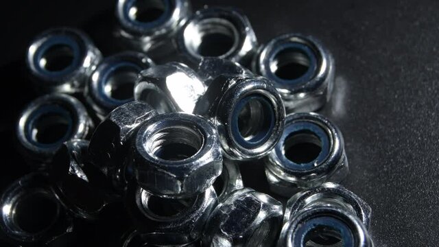 Nuts hardware rotating on black background