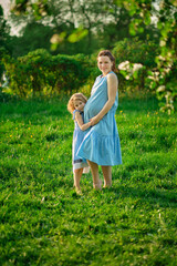 nature scene with family outdoor lifestyle. Mother and little daughter playing together in a park. Happy family concept. Happiness and harmony in family life.