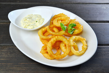 Homemade Fried Onion Rings with sauce on a plate