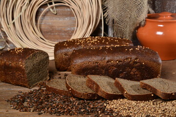 Fresh sliced bread with seeds textile wood and milk pot  on back