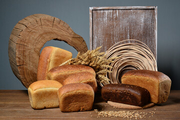Assortment of baked bread on wooden table background