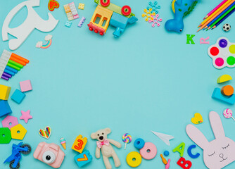 Variety of plastic and wooden kids toys on blue background