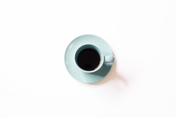 Blue cup of coffee on white background. top view, copy space