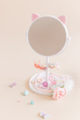 Round mirror on a leg with a stand for storing girly jewelry