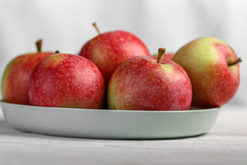 Apples on plate, red and green apples