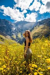 Fototapeta na wymiar Young tourist woman enjoy view in Kazbegi, Georgia. The Mount Kazbegi in summer. Travel in georgia