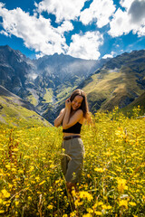 Fototapeta na wymiar Young tourist woman enjoy view in Kazbegi, Georgia. The Mount Kazbegi in summer. Travel in georgia