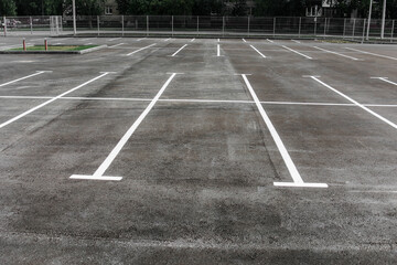 Parking on the street next to the house. new paved empty parking lot with new painted lanes © Anna