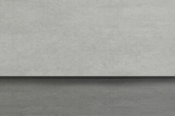 A gray wall in a building with a gray floor and baseboard.