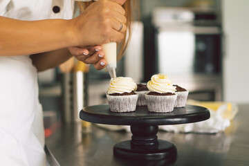 Confectioner girl is preparing a cupcakes. Concept ingredients for cooking flour products or dessert