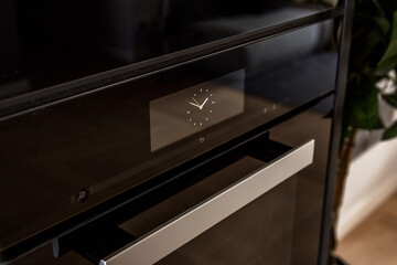 Modern black oven with timer