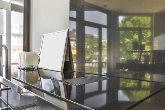 Black glass splashback in modern kitchen