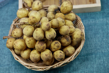 bunch of ripe Longkong fruit in wicker basket
