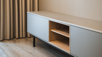 Close-up of new wooden tv stand. Modern interior of apartment.